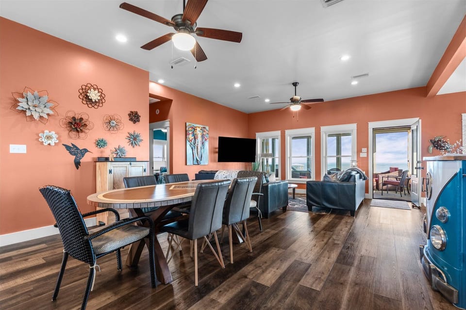 Gather around your spacious dining table where conversations flow as easily as the ocean breeze through open doors to your private balcony.
