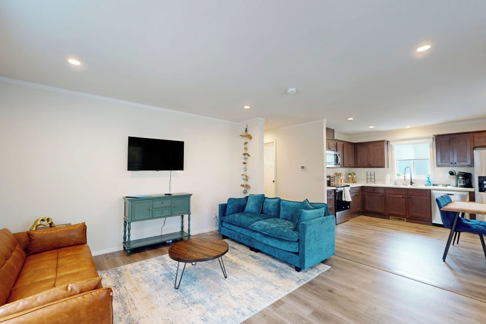 Open living space with modern seating and kitchen access.