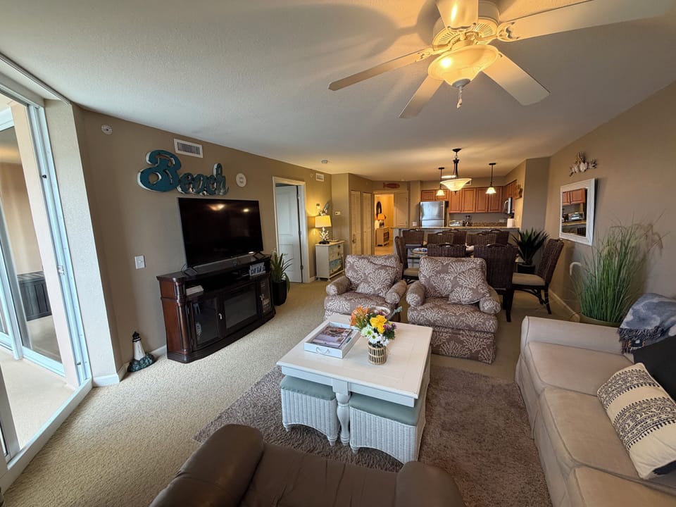 Sink into plush seating in your spacious beachside retreat, where coastal comfort meets modern convenience in this beautifully appointed living space.