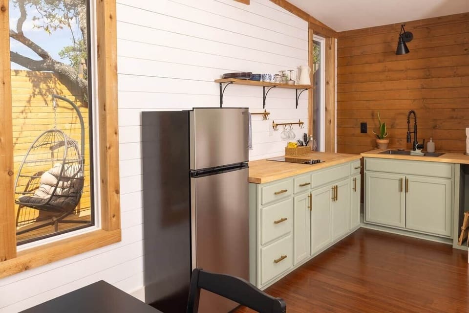 Kitchen has stove, cooking essentials, drip coffee, French press, microwave and hand-picked glassware.