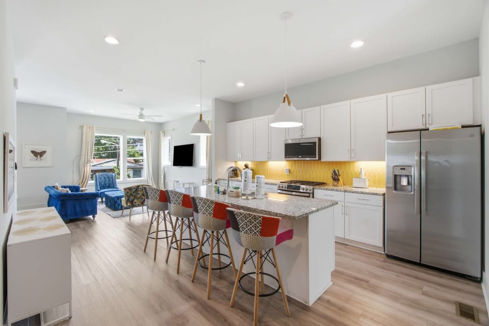 Kitchen & Living Space, bright and airy with unique decor and a stylish breakfast bar, perfect for gatherings!