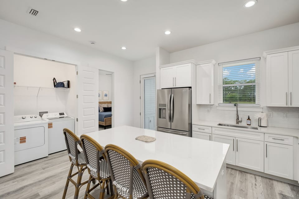 Your bright, open kitchen with modern appliances, spacious island seating, and convenient in-unit laundry makes meal prep and longer stays effortless.