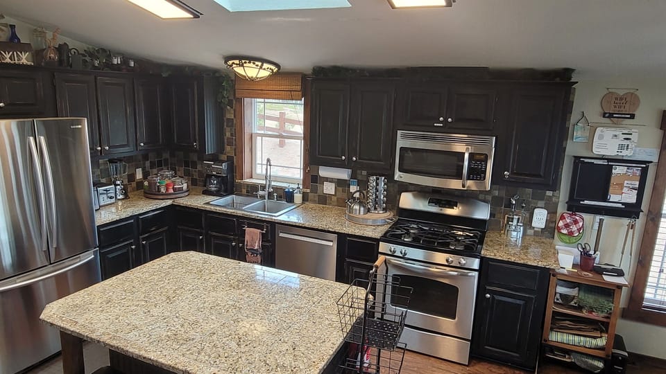 The Kitchen has high-end appliances: browning microwave, dishwasher,  gas stove & more.  It is stocked with cookware for any occasion, and an assortment of spices.