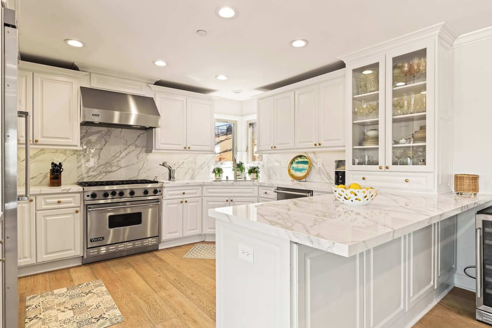 Light filled kitchen with a center island and clean finishes.