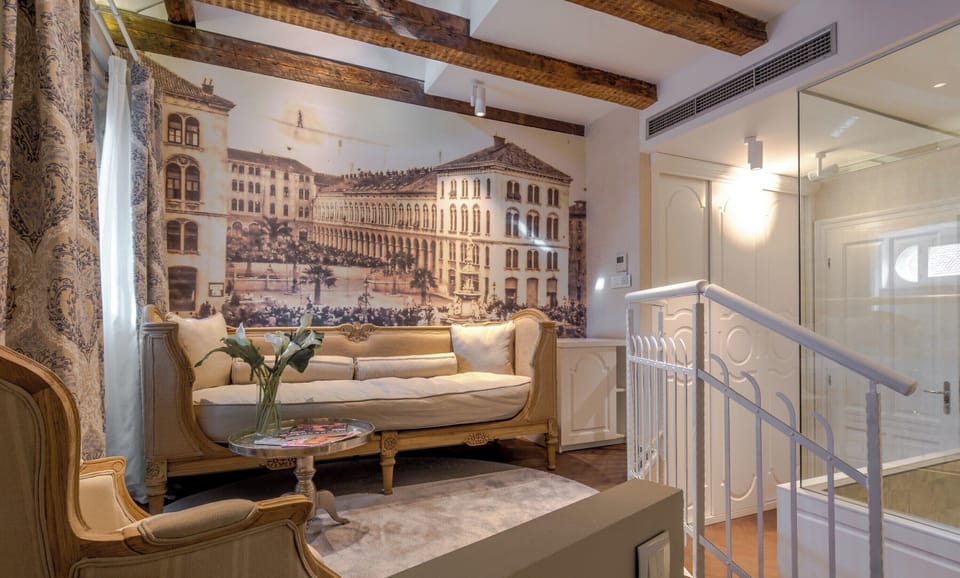 Elegant raised lounge area with vintage-style seating.