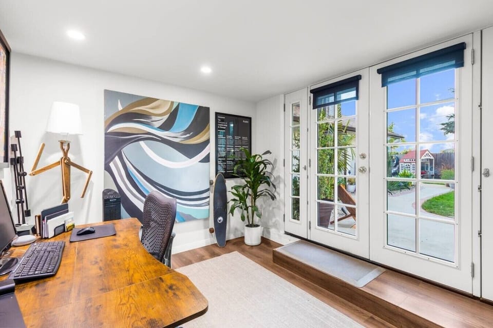 The home`s flexibility extends to its workspaces — a dedicated studio with French doors, a full desk, and room to think.