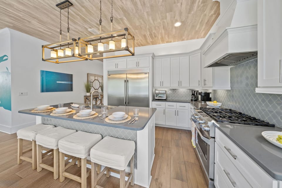 Chef's kitchen with oversized island seating, gas range, and everything you need for a full week of family meals.