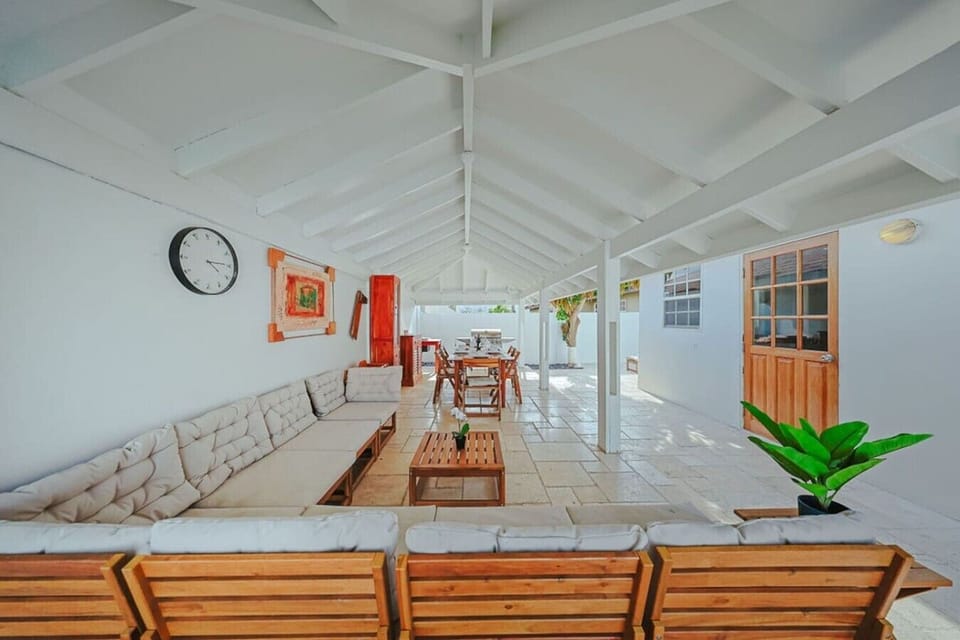 Covered outdoor lounge and dining area with plenty of seating—great for group meals, evening drinks, or relaxing in the shade while still enjoying the tropical breeze.