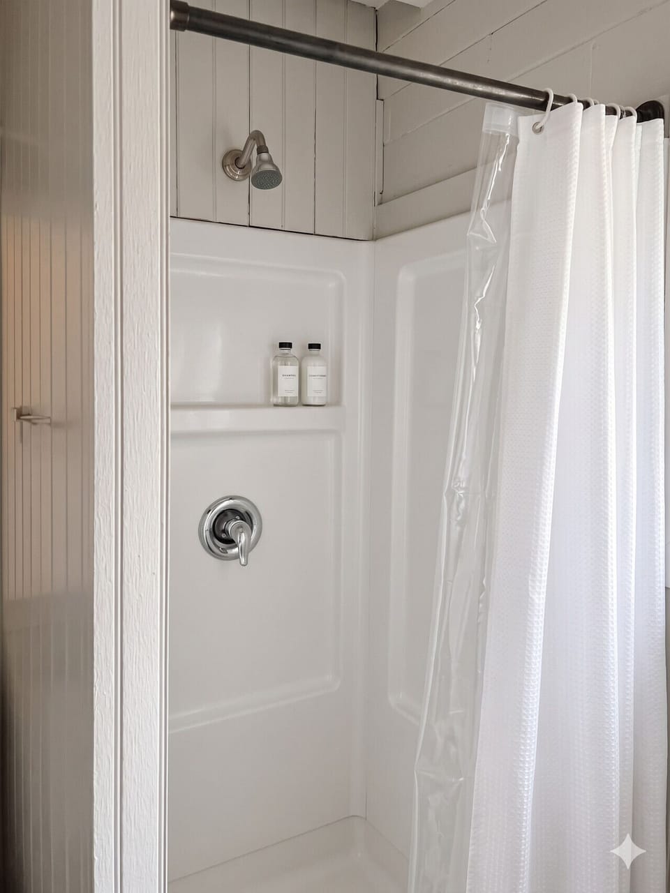 Walk-in shower with fresh towels and Cedar toiletries
