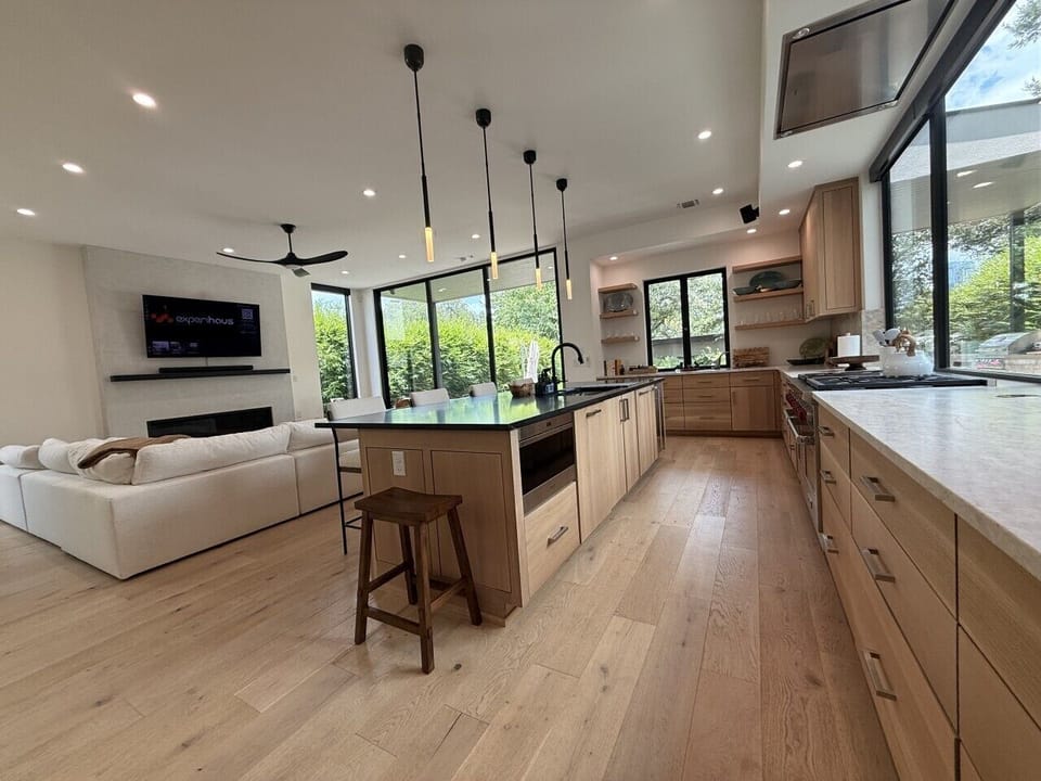 Open-concept living area with a luxury kitchen, oversized island, and seamless flow to the lounge—ideal for group meals, conversation, and relaxing together.