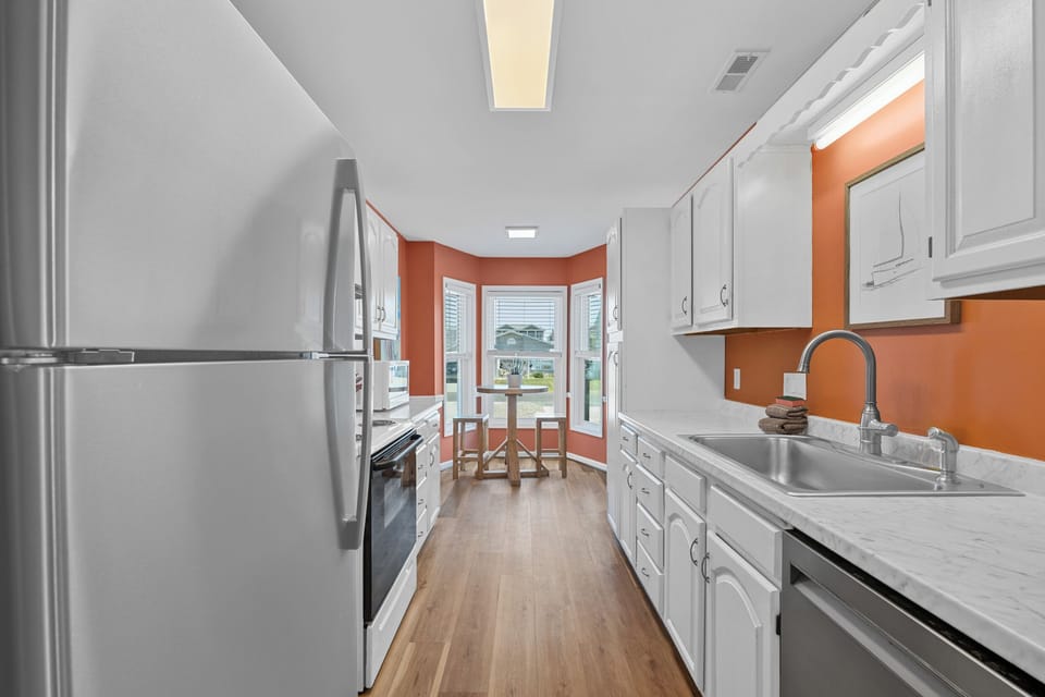 Fully equipped galley-style kitchen stocked with cookware, coffee essentials, and everything needed to prepare meals during your stay.