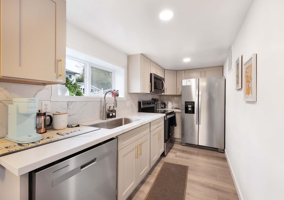 Fully equipped kitchen with modern appliances and ample prep space.