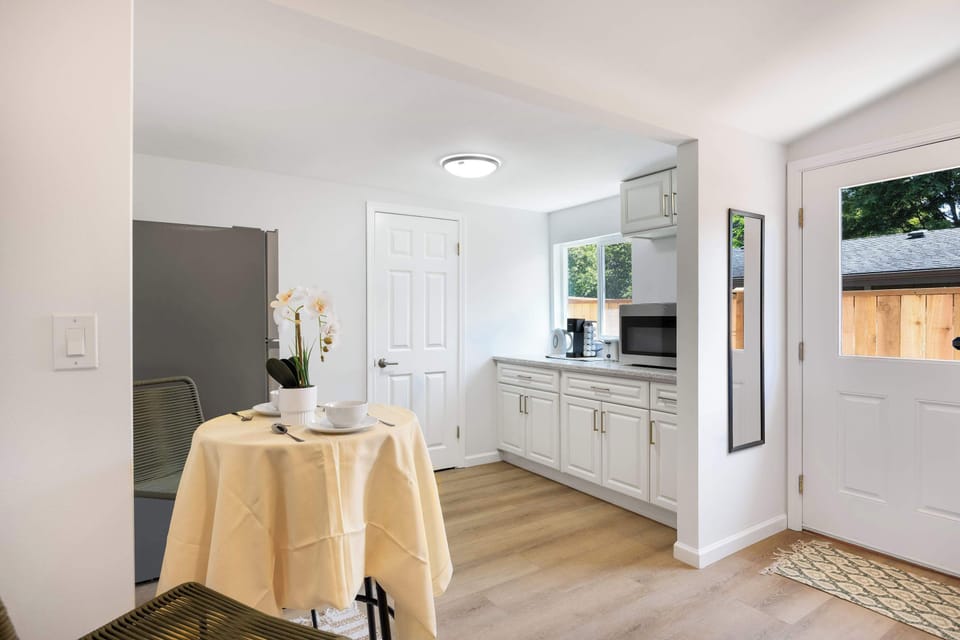 Open dining and kitchenette area with simple, modern finishes and plenty of natural light.
