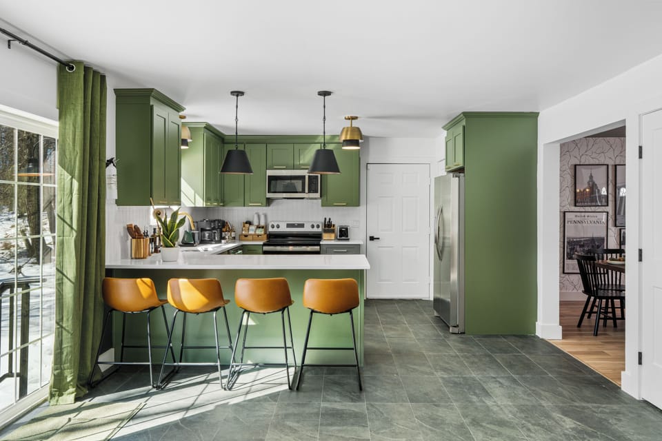 Fully stocked kitchen with island seating, modern appliances, and everything you need to cook and gather—including helpful extras like a blender and slow cooker