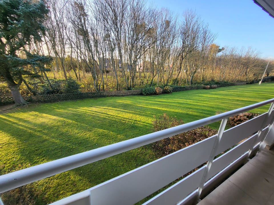 Balcony with a view of a well-kept garden