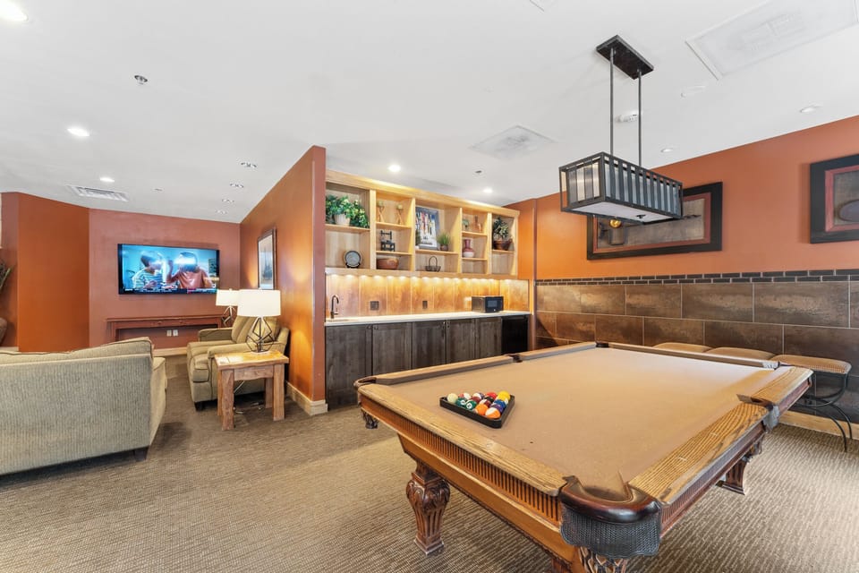 Lobby with a seating area, TV, and pool table.