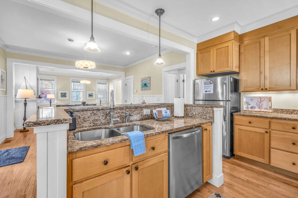 You'll love preparing meals in this fully equipped kitchen with granite countertops, stainless steel appliances, and warm wood cabinetry.