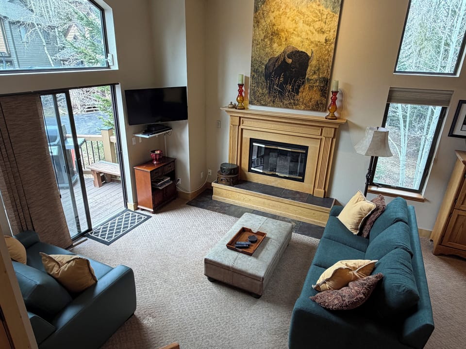 Living Room Opens to Grand Deck with Seating and BBQ