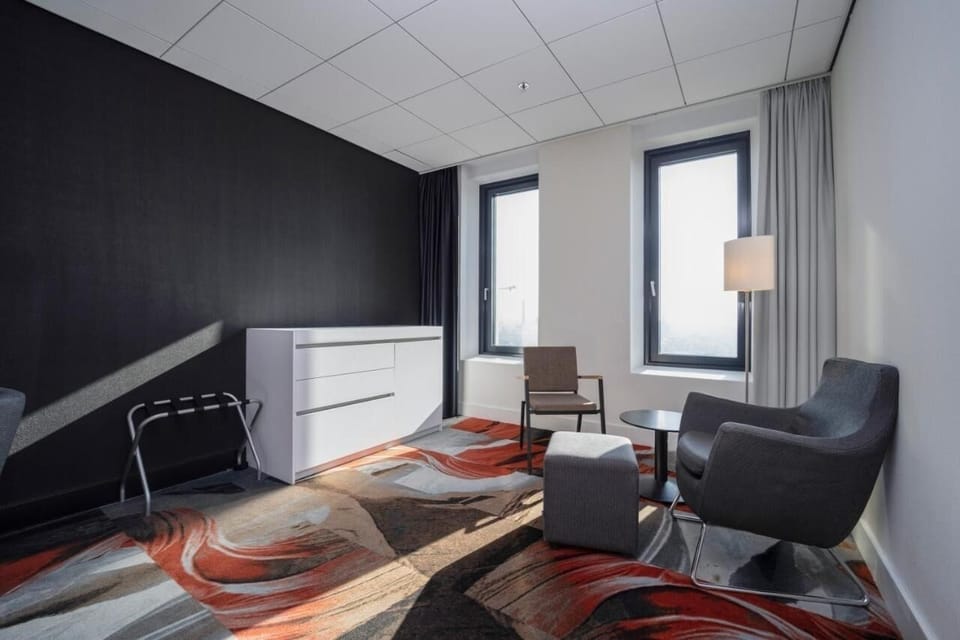 Lounge by the windows with a cozy chair and ottoman.