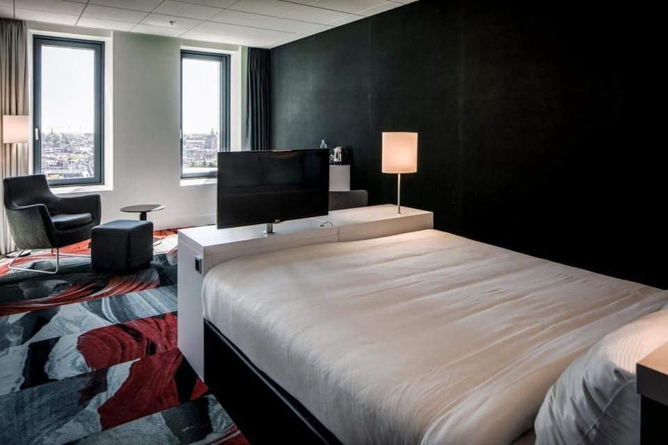 Wake up to skyline views from your serene, modern bed.