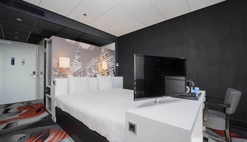 Unwind on crisp linens with cinematic TV viewing.