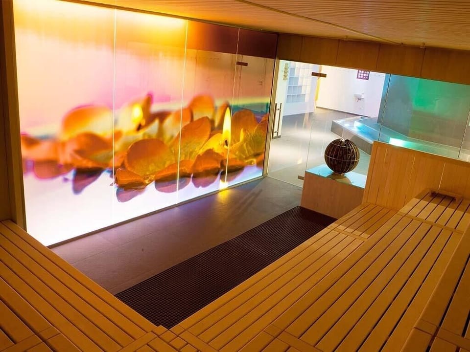 Recharge on warm benches beside glowing wellness art walls.