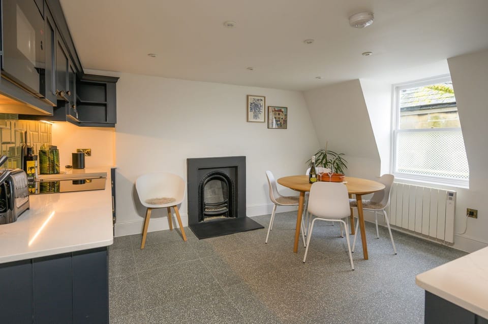Contemporary kitchen with integral appliances and a dining area