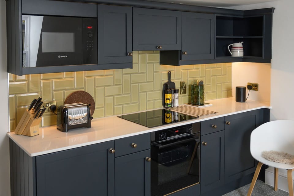 Contemporary kitchen with integral appliances and a dining area
