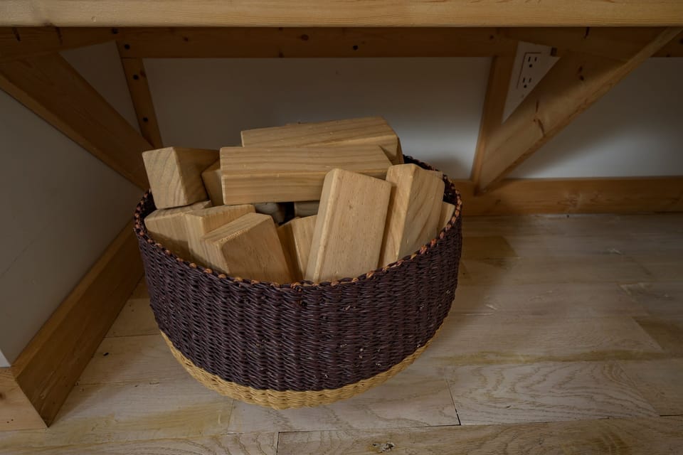Playful Retreat: Enjoy family games with this stylish basket of wooden blocks! Fun awaits!