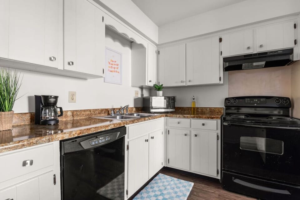 Well-equipped kitchen featuring granite counters and ample storage.