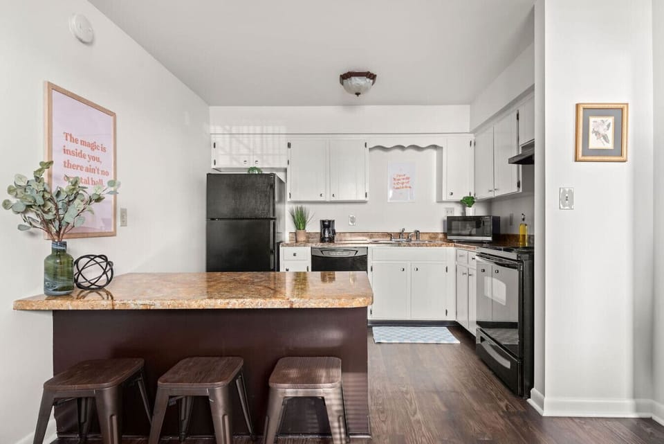 Functional kitchen featuring open counter space and warm hardwood floors.