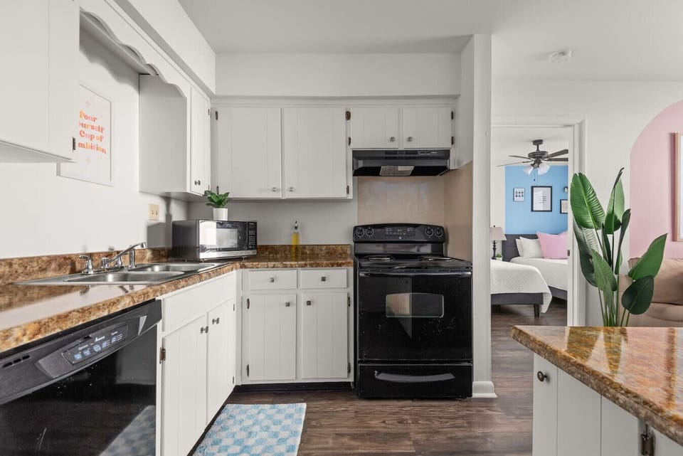 Functional kitchen featuring black appliances and bright, airy sightlines.