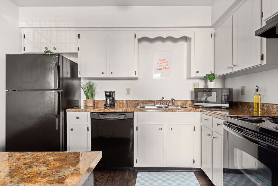 Bright kitchen featuring ample cabinet storage and durable tile flooring.