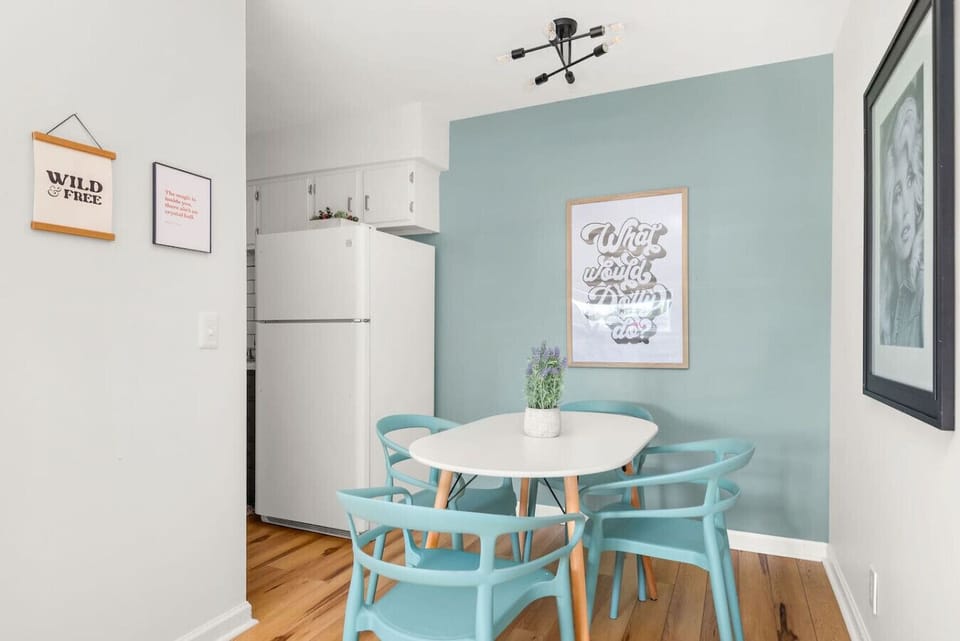 A pink accent wall and Nashville decor give this bathroom a playful personality-driven vibe.
