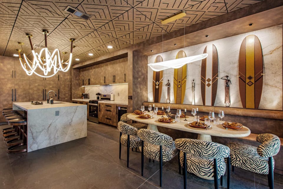 The Heart of Zanzibar
The open-concept chef’s kitchen and dining room feature a custom waterfall island, handcrafted LED chandelier, designer finishes, and seating that brings everyone together for cooking, dining, and celebrating.