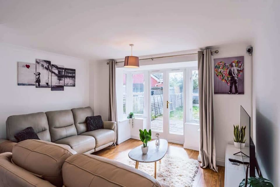 Modern living room with garden access, comfortable sofa, and natural light

