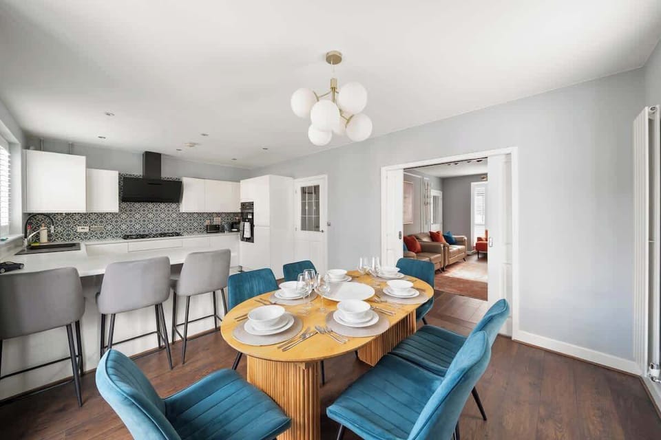 Open dining area connected to sleek, modern kitchen space