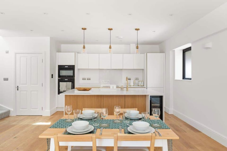 Stylish open kitchen dining area with clean minimalist design
