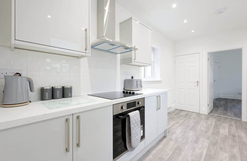 Modern kitchen with integrated appliances clean surfaces and functional layout
