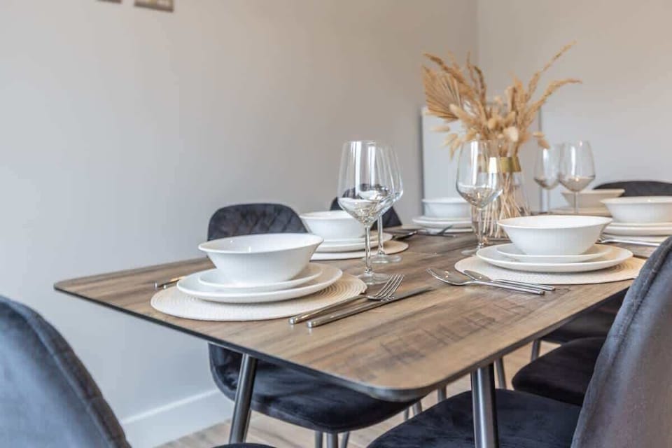 Simple dining area with set table ready for guests arrival
