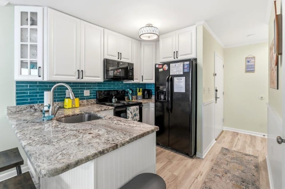 Updated kitchen with granite countertops and all necessary amenities for the perfect vacation stay.