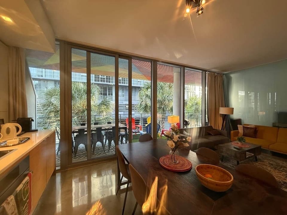 Open-concept loft with floor-to-ceiling windows and full-length balcony
