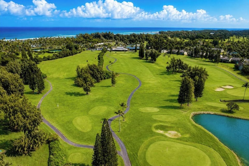 The clubhouse and practice greens at Kuilima Estates offer a convenient launch point for a round of golf, surrounded by wide fairways and ocean breezes.