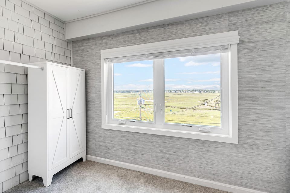 View of the marsh from the bedroom as well as a clothes rack
