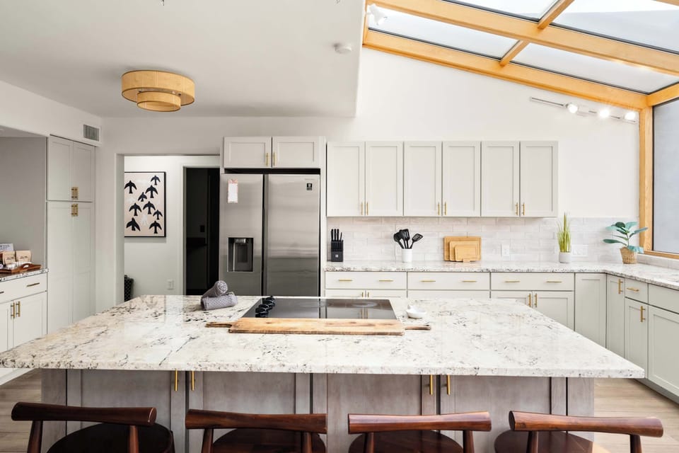 Cook, Gather, and Shine – Featuring a stunning glass-enclosed design that floods the space with natural light, this breathtaking sunroom kitchen boasts high-end appliances and ample storage, making it the ultimate space for effortless entertaining.