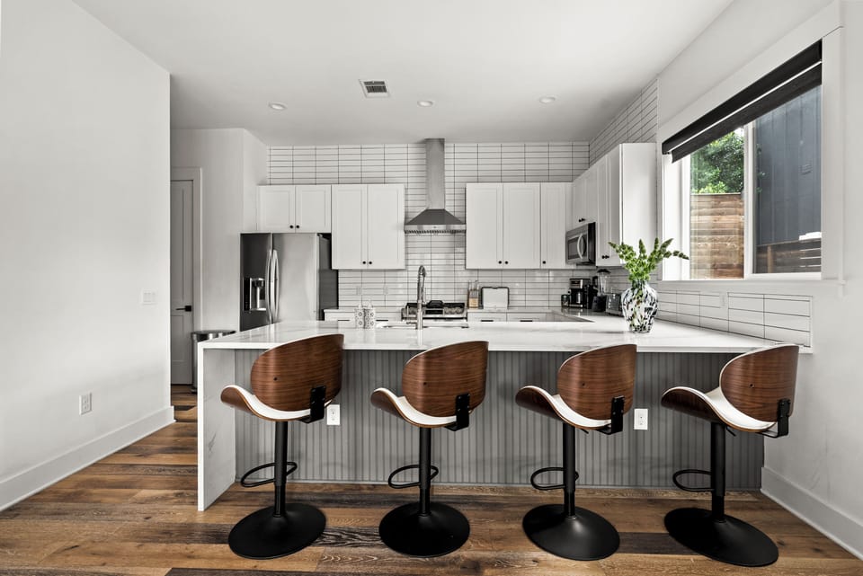 Bright modern kitchen with waterfall island and seating for four