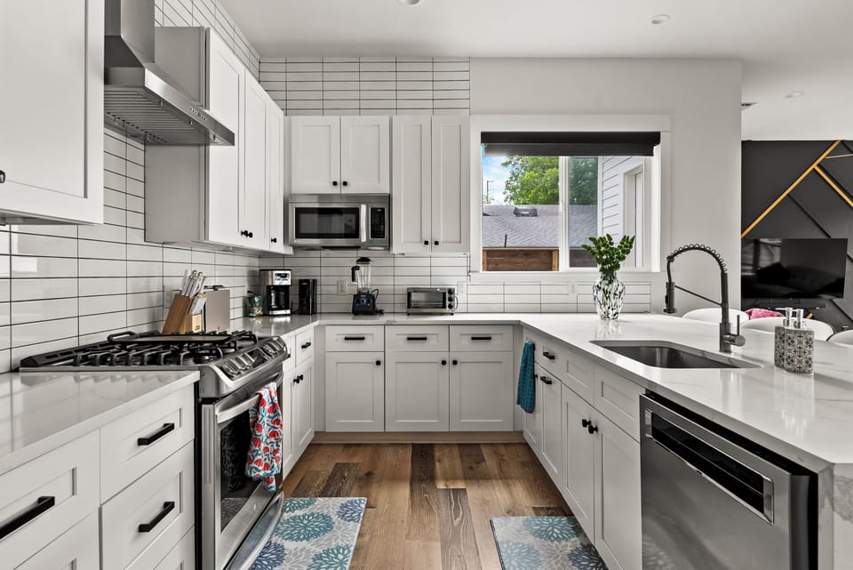 Bright modern kitchen with quartz counters and stainless appliances