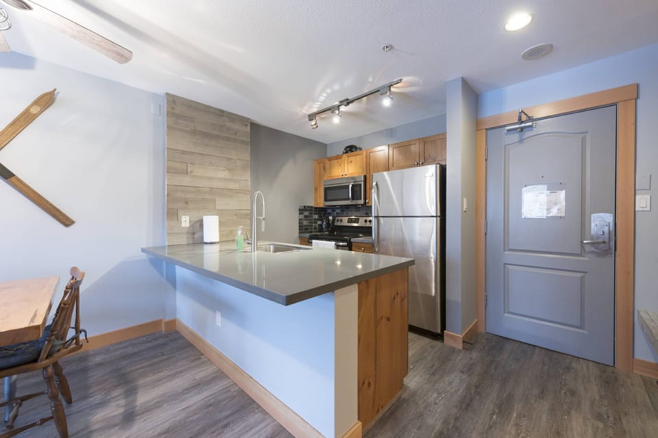 Modern kitchen with full size fridge ,stove, microwave and dishwasher