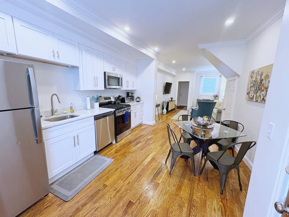 Bright kitchen with stainless steel appliances, white cabinetry