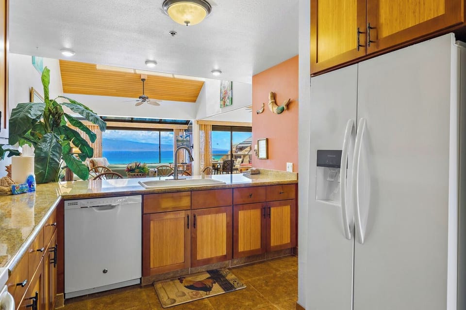 Prepare meals with ease in your fully equipped kitchen featuring granite countertops and custom cabinetry. SOK-292